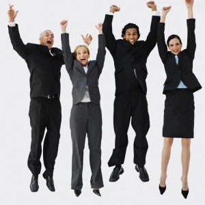 Front view portrait of four business executives jumping with arms raised